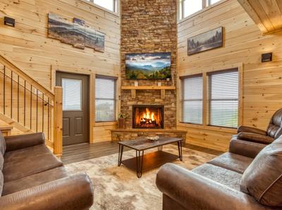 In The Clouds living room with seasonal stone encased gas fireplace