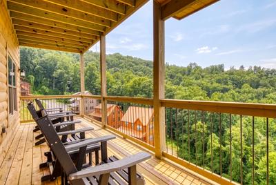 In The Clouds main level deck with Adirondack chairs and mountain views