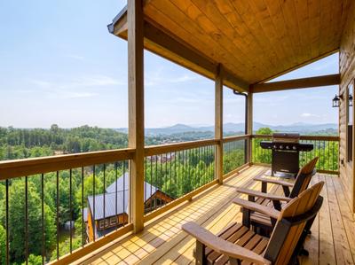 In The Clouds main level deck with panoramic mountain views