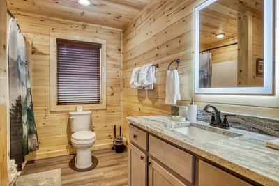 In The Clouds upper level bathroom with heated mirrors and a tub/shower combo