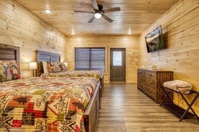 In The Clouds lower level bedroom with two queen size beds and 58 inch TV