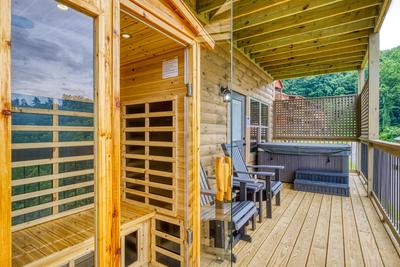 In The Clouds lower level deck with sauna and hot tub