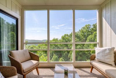 Ober the Rainbow balcony with mountain views and cushioned chairs
