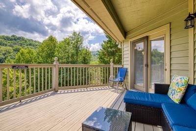 Triple the Mountain View upper level deck with cushioned furniture with mountain views