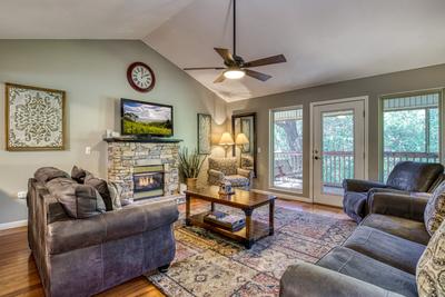 Whispering River living room with stone encased fireplace