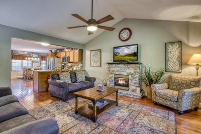 Whispering River living room with stone encased fireplace