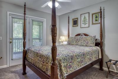 Whispering River main level bedroom two with queen size bed