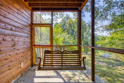 Whispering River lower level patio with swing