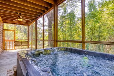 Whispering River lower level patio with hot tub