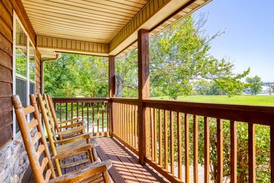 Whispering River covered entry deck with rocking chairs