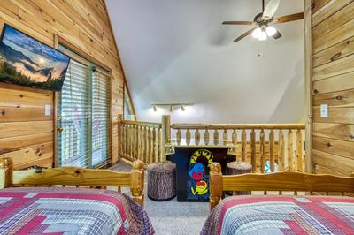 Forest Hollow upper level loft area with cocktail arcade system and twin size beds