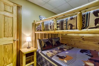 Forest Hollow lower level bedroom with queen over queen bunk beds