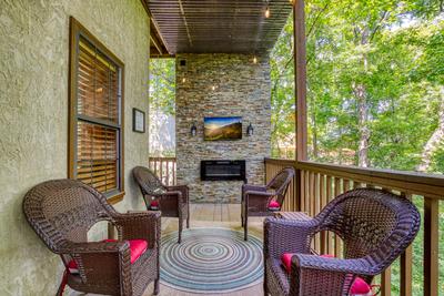 Forest Hollow lower level deck with sitting area and fireplace and TV