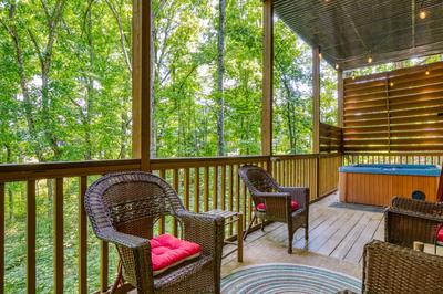 Forest Hollow lower level deck with sitting area and hot tub
