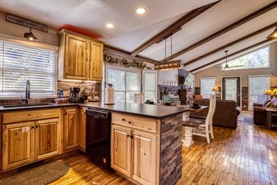 The Playful Bear fully furnished kitchen, dining area, and living room
