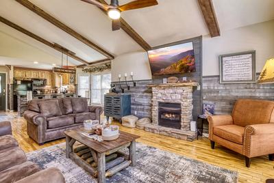 The Playful Bear living room with stone encased seasonal gas fireplace