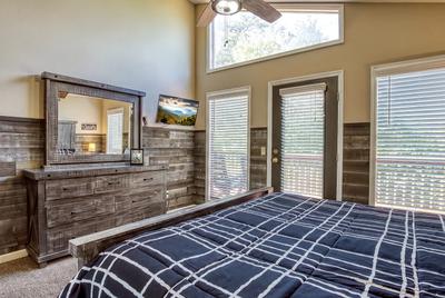 The Playful Bear main level bedroom two with 32 inch TV and king size bed