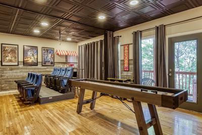 The Playful Bear lower level game room with shuffle board table