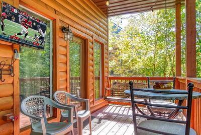 The Playful Bear lower level deck with TV and sitting area