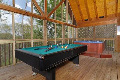 Hot Tub and Pool Table on screened in porch