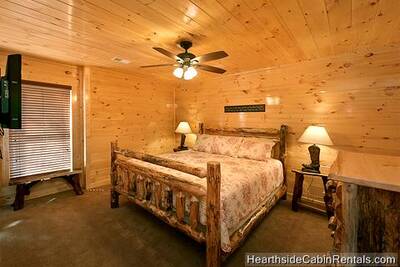 Relaxing king bedroom with flat-screen tv at A Grand View Lodge cabin in Pigeon Forge