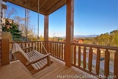Porch swing on private deck at Mountain Top Retreat Cabin in Pigeon Forge.