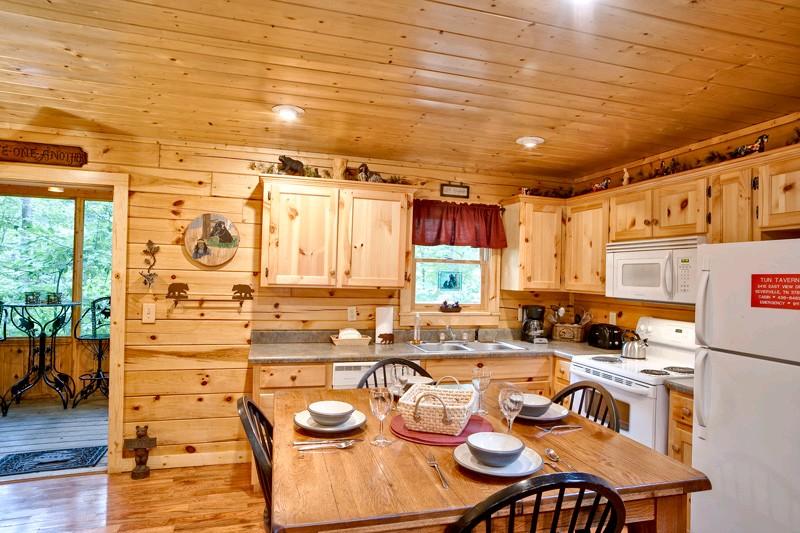 Full kitchen with entry way to the deck