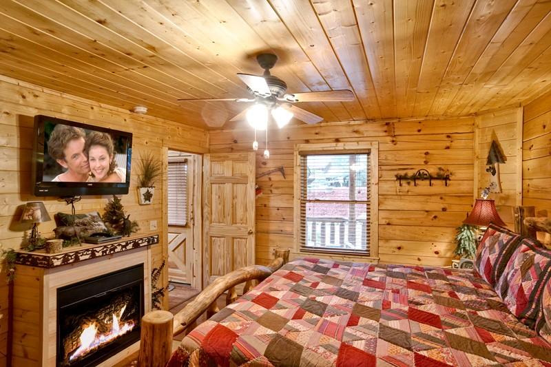 Bedroom with jacuzzi tub, fireplace and TV