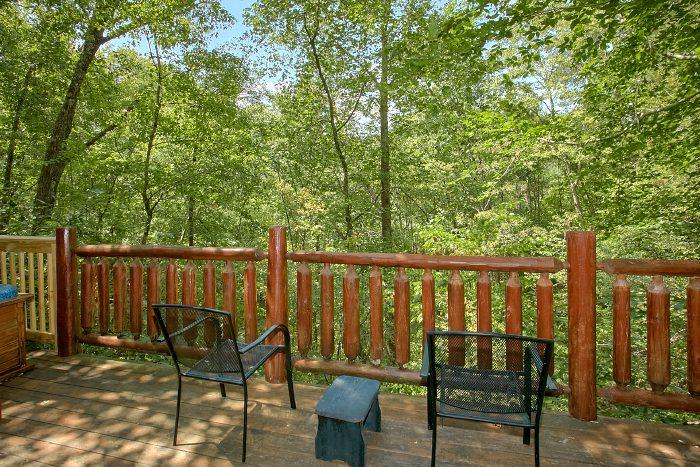 Back deck area with chairs next to the hot tub