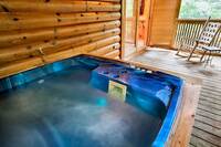 Secluded and private screened in deck off the bedroom with a large hot tub