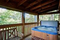 Hot tub and porch swing at Afternoon Delight - 1 bedroom cabin near Pigeon Forge