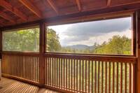 Screened deck with mountain view of this 2 bedroom cabin that sleeps 4