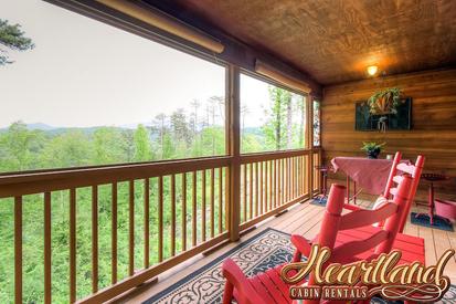 Wooden rocking chairs on the deck with views of the mountains