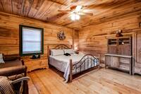 King bed in the Master Bedroom of this Wears Valley Cabin Rental