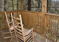 Relax in the rockers on the deck on this one bedroom cabin near Gatlinburg, TN