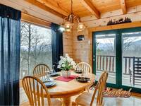 Dining table off the kitchen with 4 chairs in this Gatlinburg cabin rental