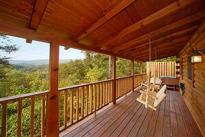 Sunset Mountain cabin swinging chair on porch