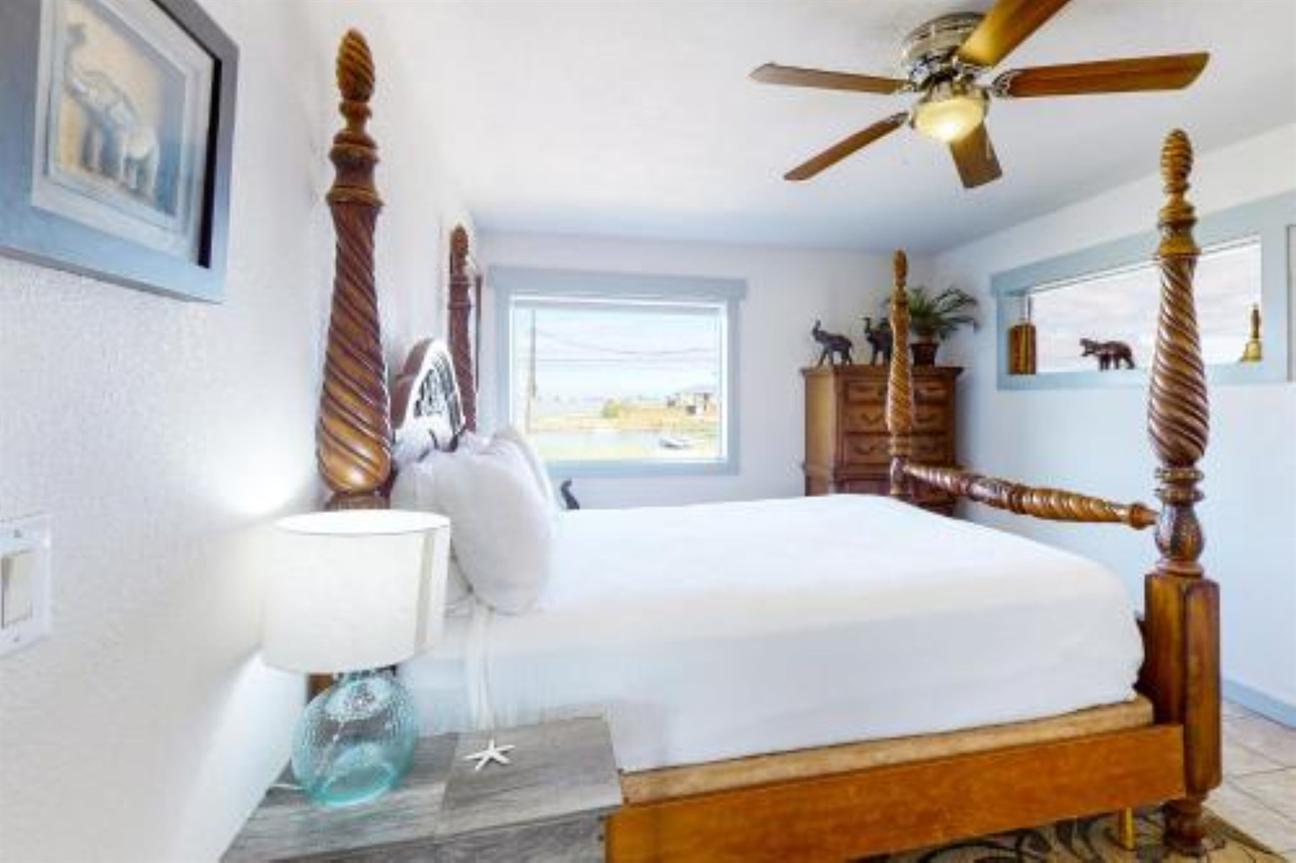 queen bed, dresser, bright windows