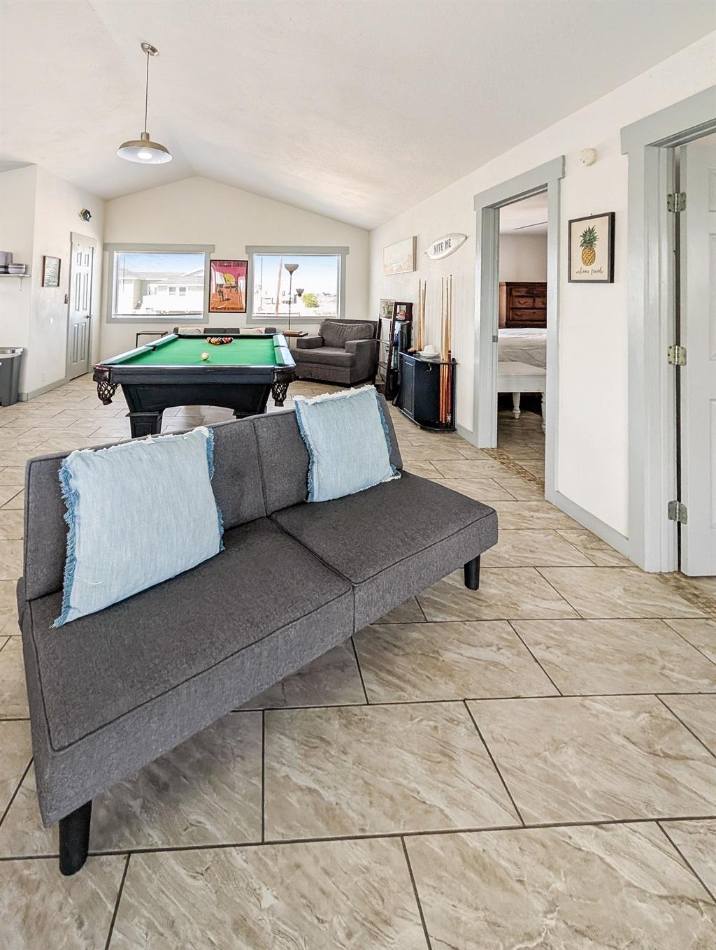 couch, pool table in the living room