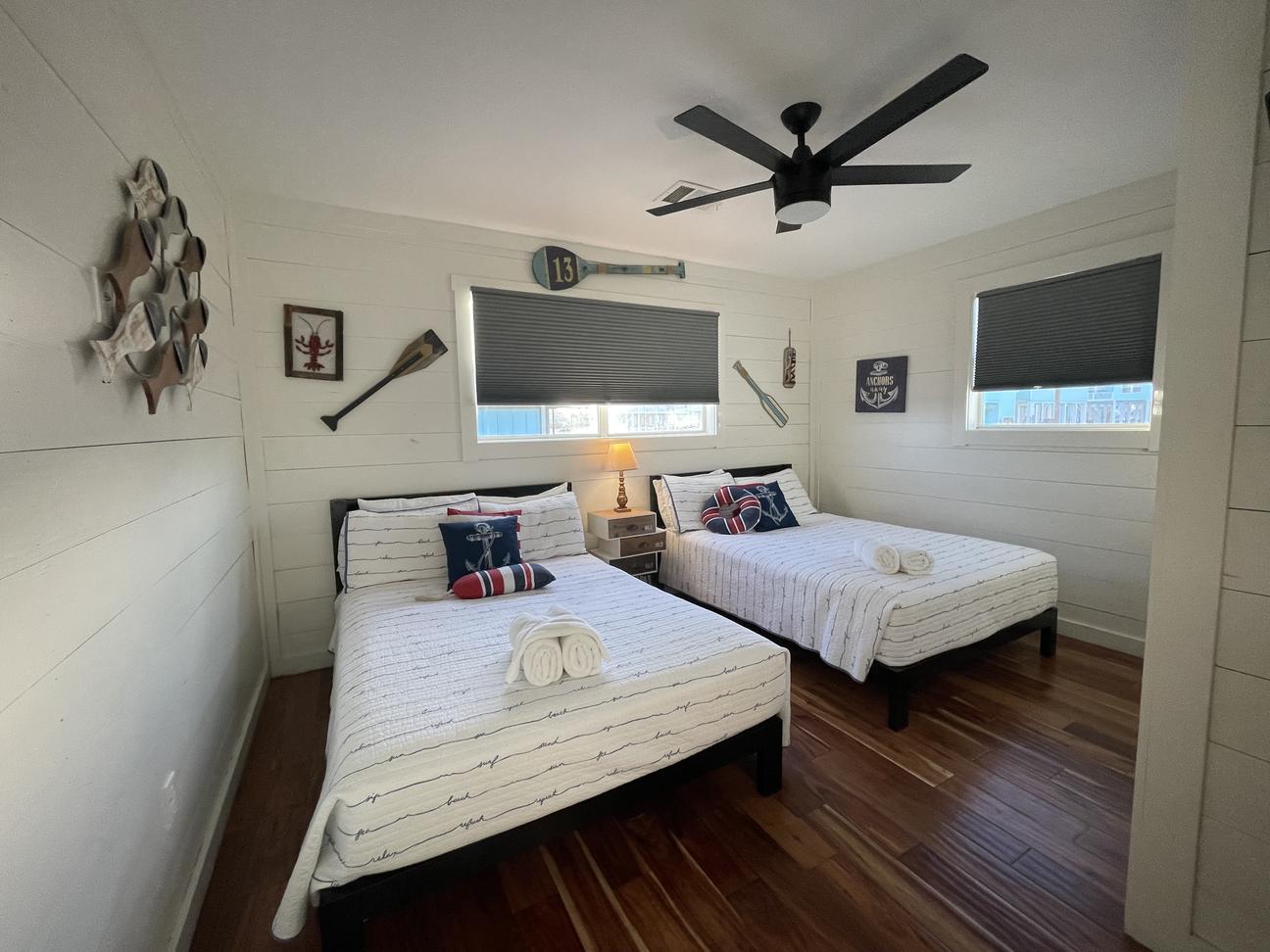 Bedroom with two full size beds and coastal decor in Rockport vacation rental