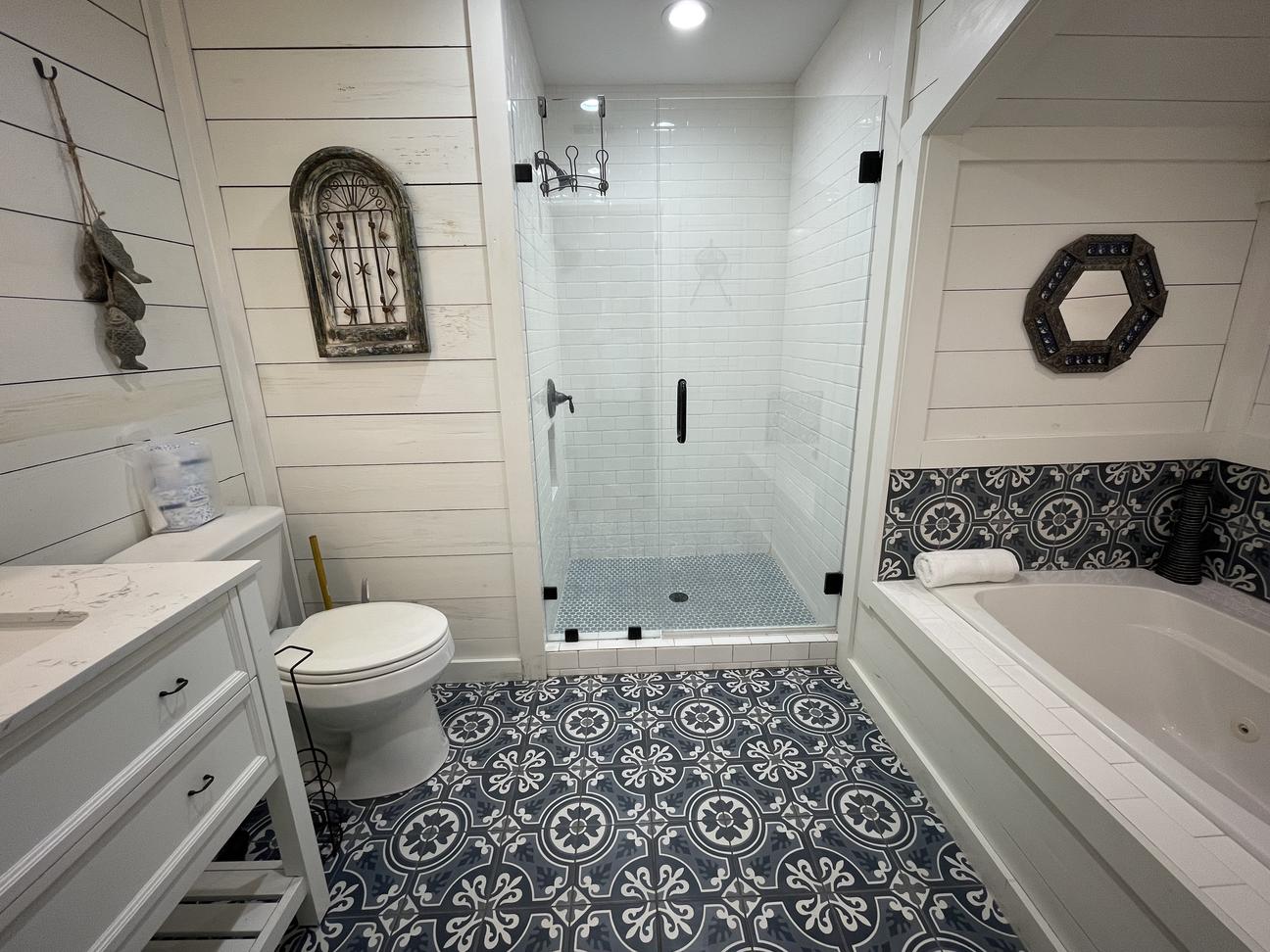 The master bathroom has a step in shower, a separate garden tub and is beautifully tiled.