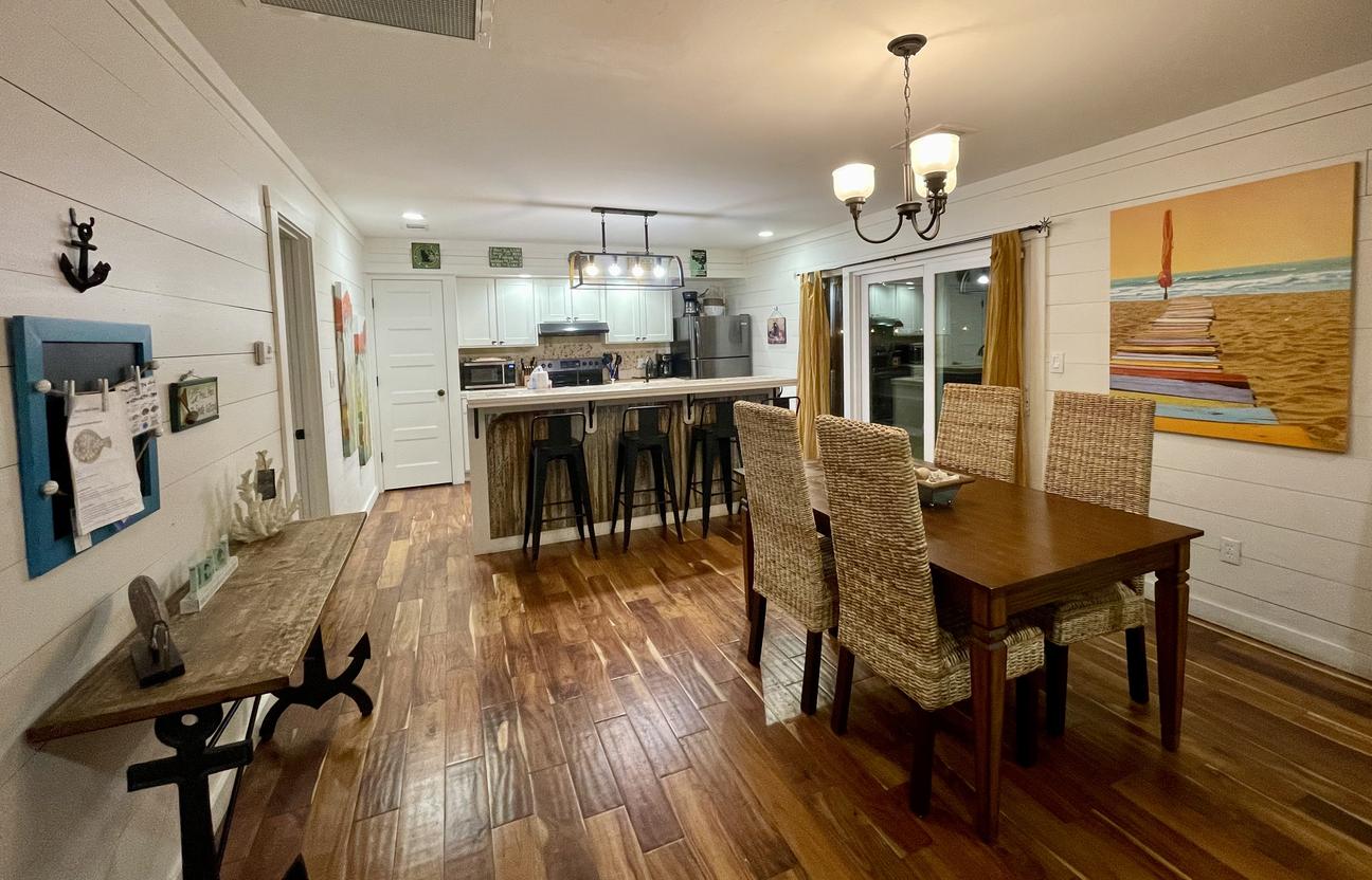 Wooden dining room table with seating for 4.