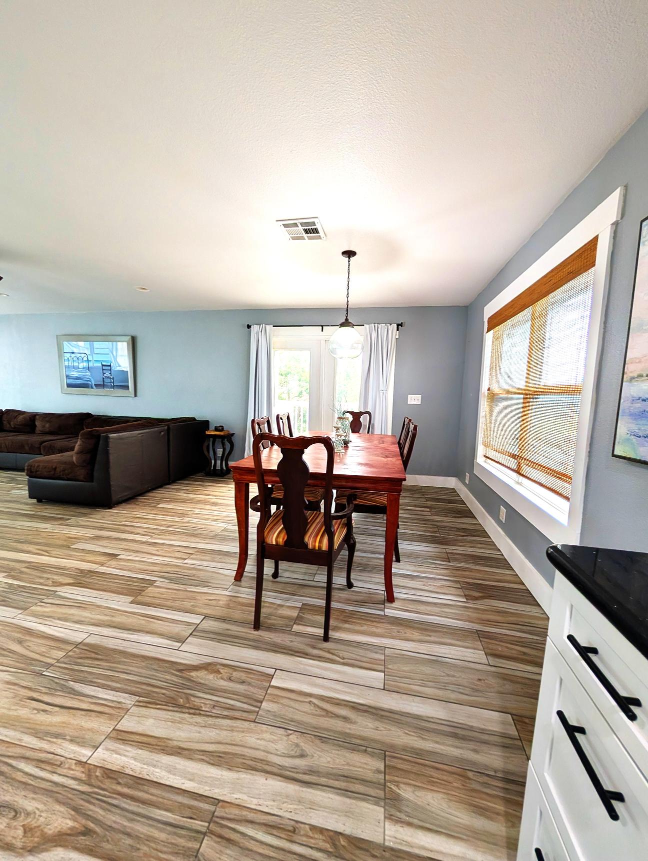 Dining room table near the kitchen, large sectional couch