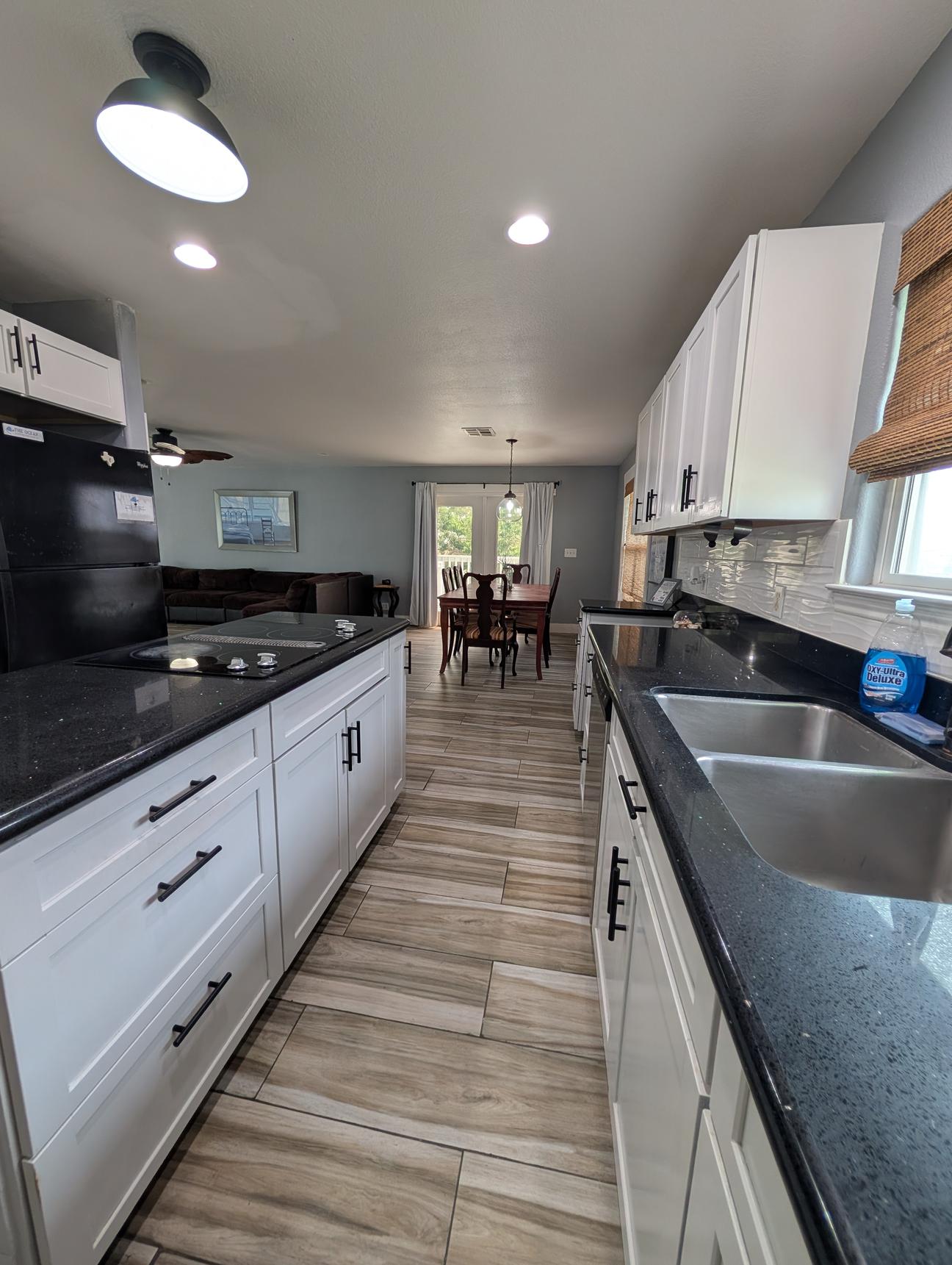 Granite counter tops in the kitchen and on the kitchen island.