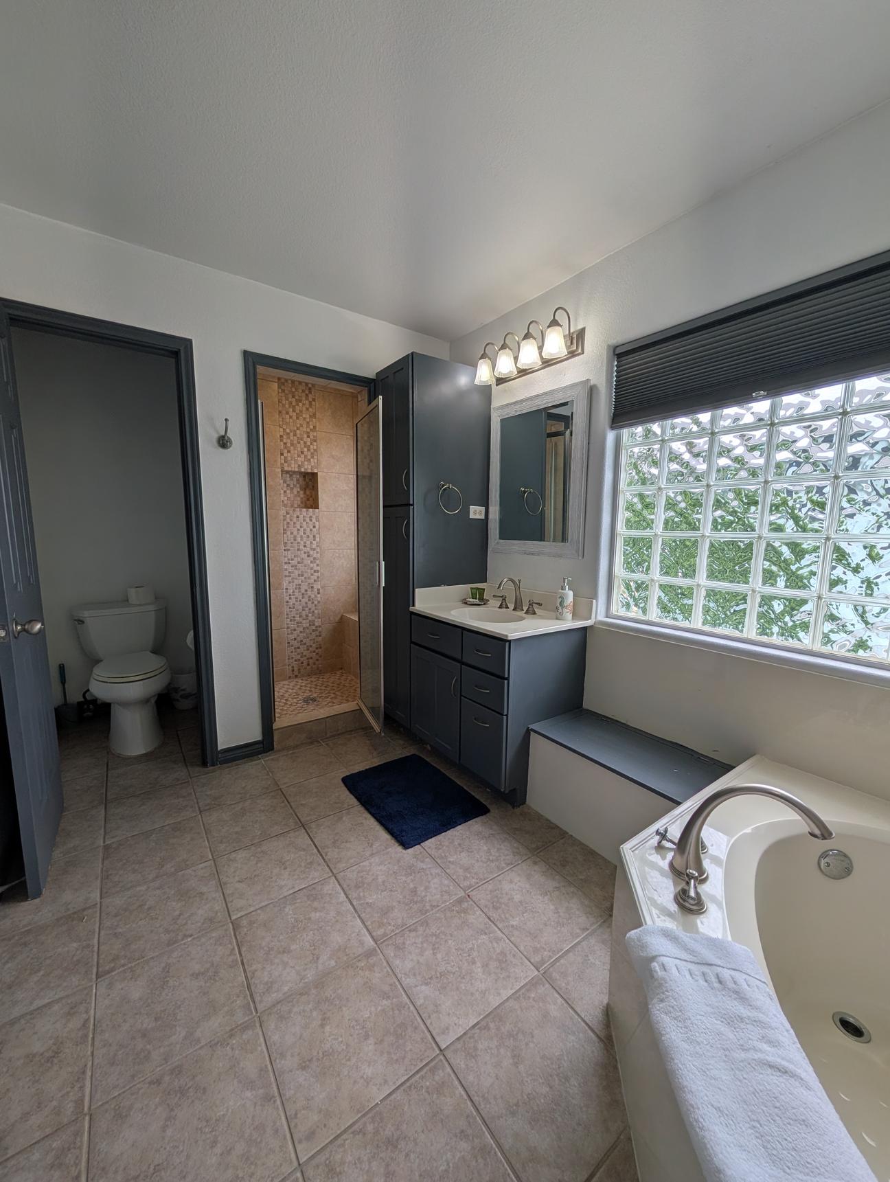 Water closet with toilet, walk in shower, large soaking tub.