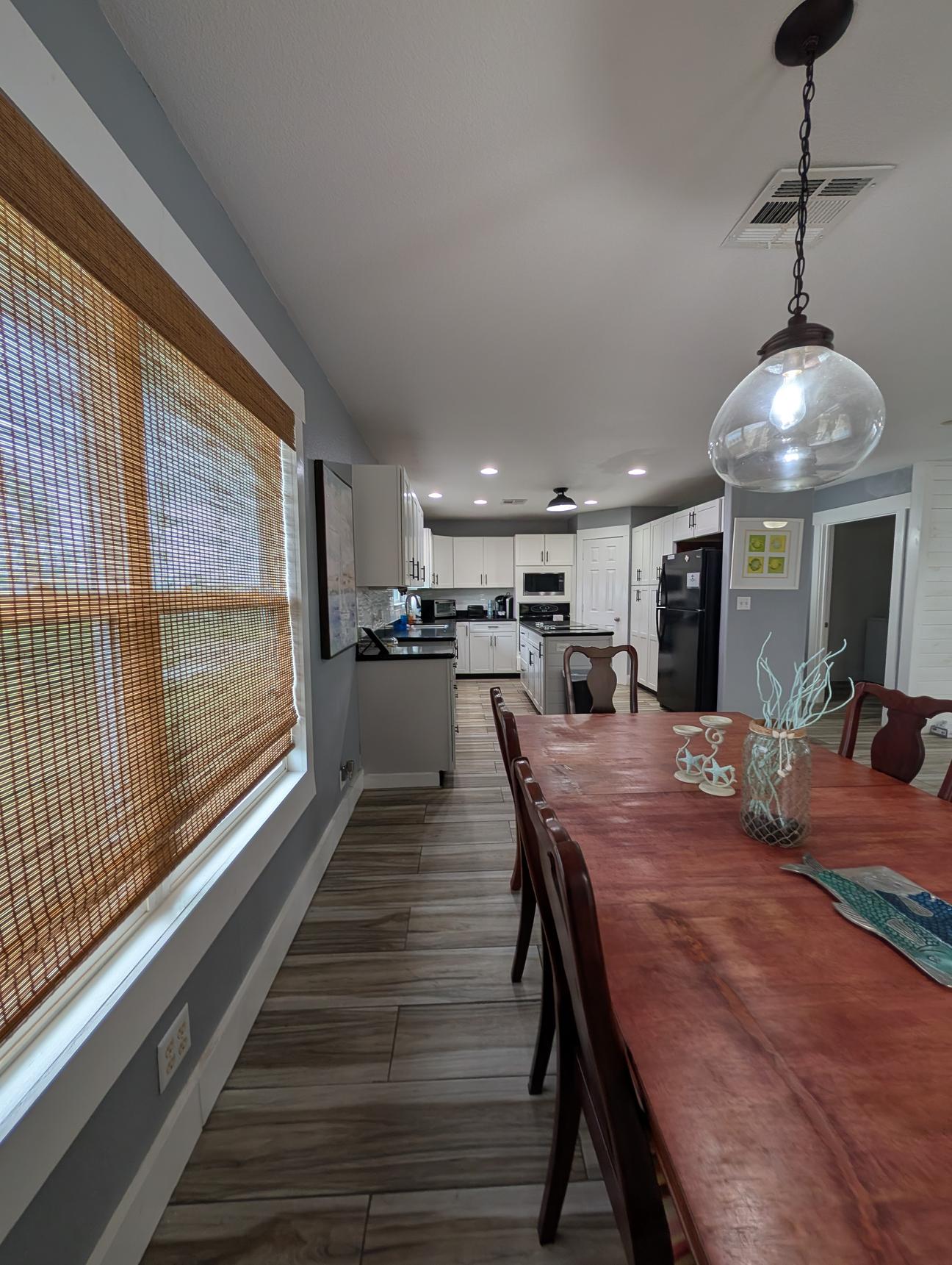 Wooden dining table with room for eight next to the window overlooking the canal.