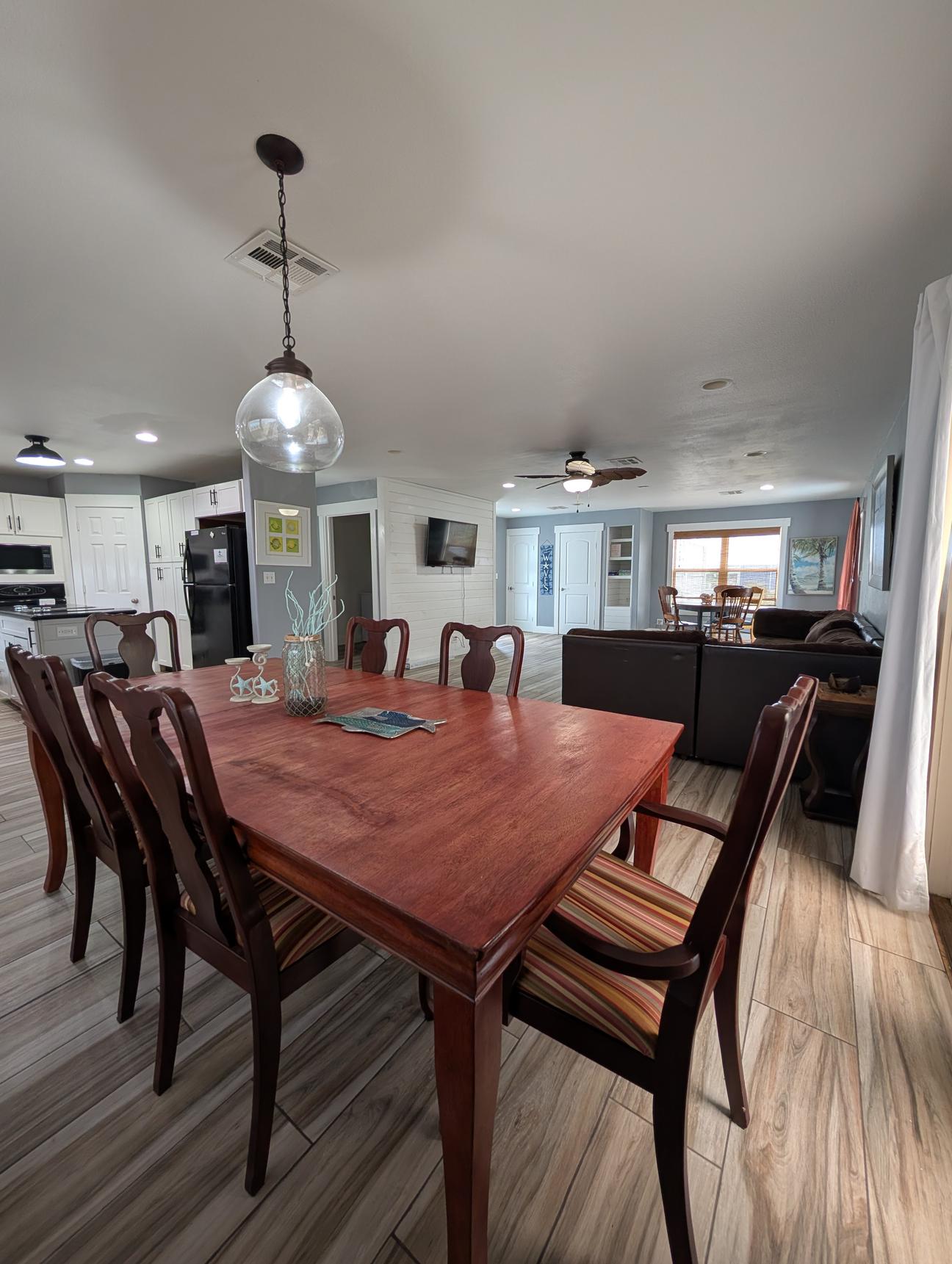 large dining room table next to sectional couch . 