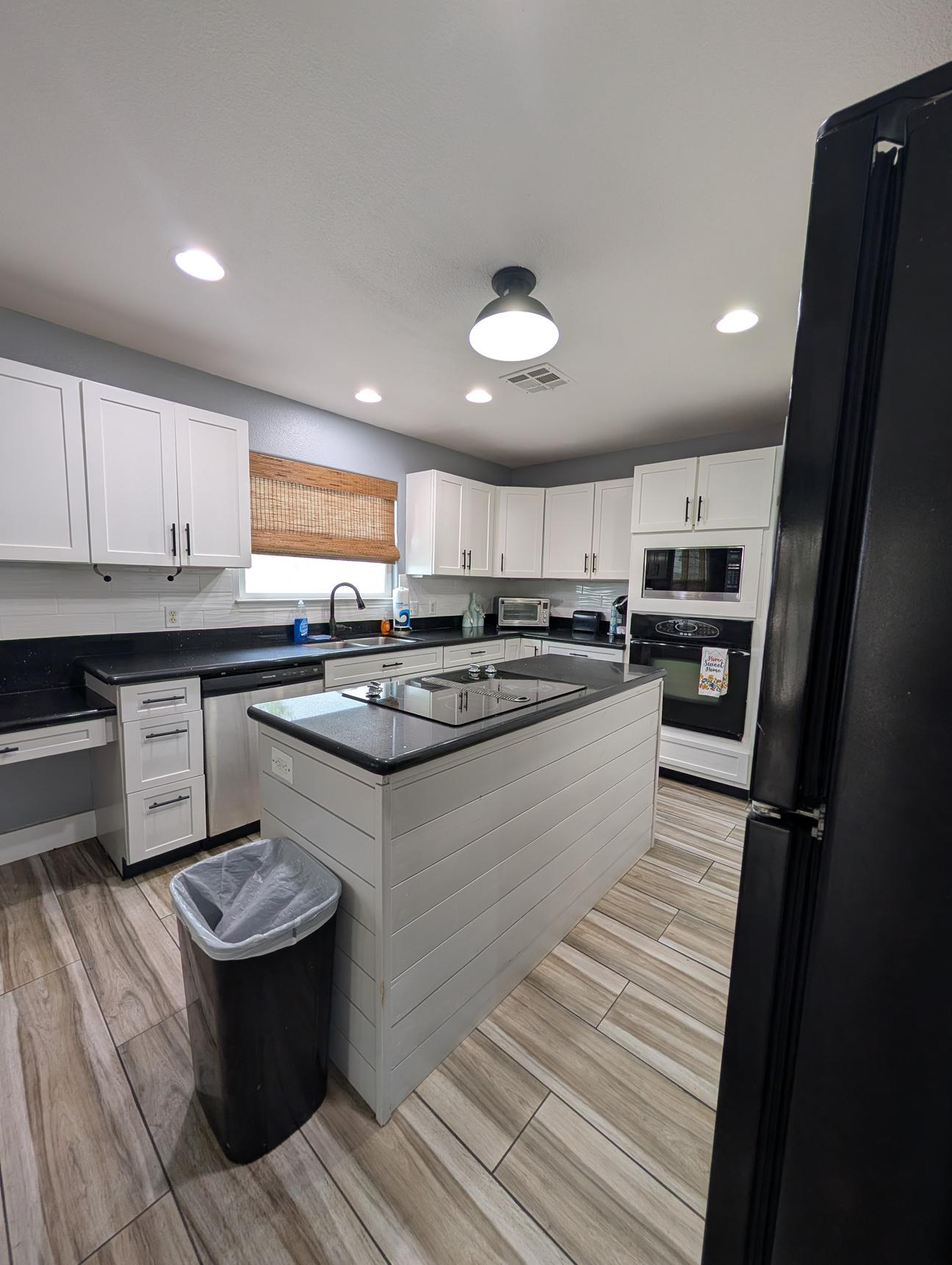 Black modern fridge, dishwasher and stove.