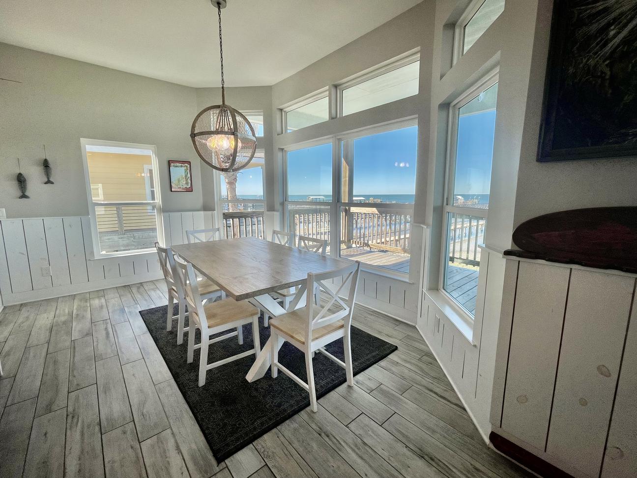 Coastal dining room with large windows overlooking the ocean