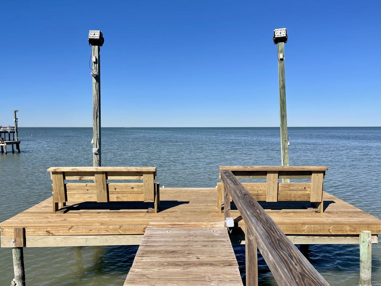 Private wooden pier with open water views.